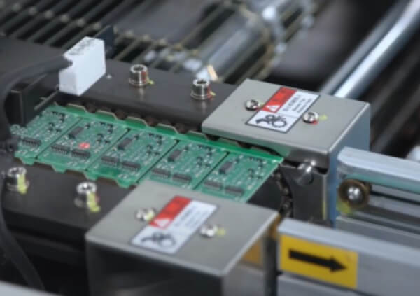 Active SMT manufacturing line showing multiple PCB boards being processed for component placement, a critical step in electronics assembly.