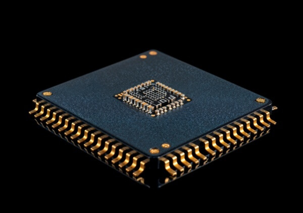 Detailed image of a packaged semiconductor component with visible metal leads, essential for connecting the chip to a PCB in electronic devices.