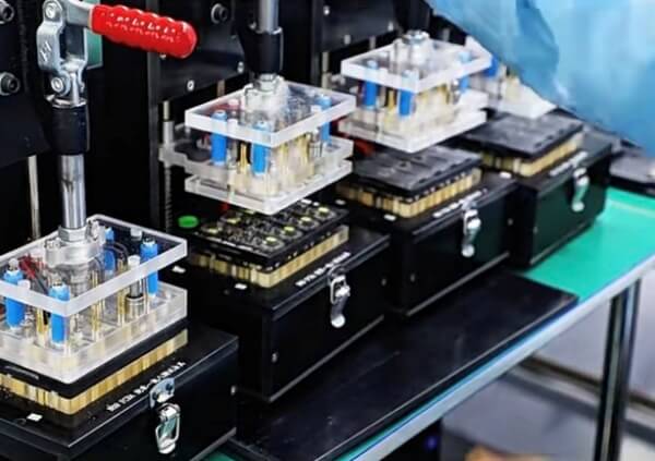 Image of a fully automated SMT production line with robotic arms assembling electronic components on PCBs for mass production.