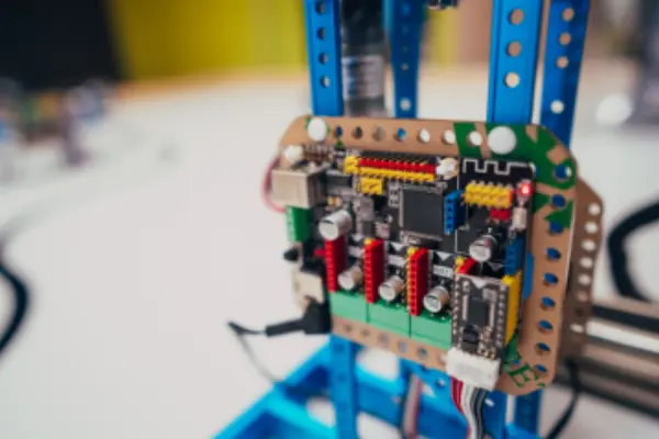 Electronic assembly control board mounted on a blue mechatronics frame