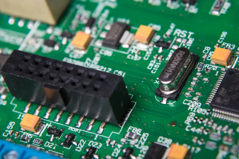 Macro of populated PCB—crystal oscillator, header, SMD parts for pcb prototyping.