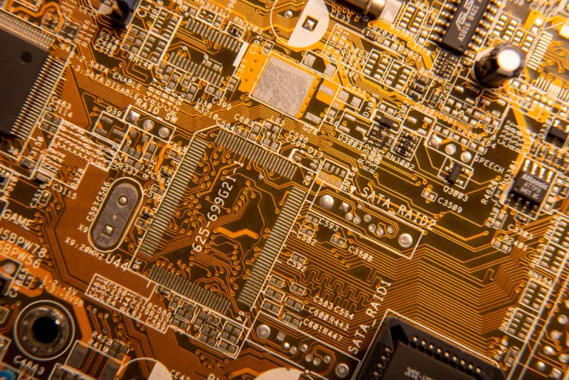 Dense multilayer motherboard region with IC, vias, and copper pours—HDI layout best practices in PCB assembly design.