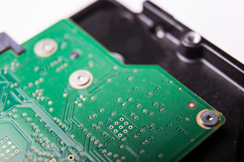 Macro of green PCB vias and pads—manufacturing details relevant to wearable electronics components assembly