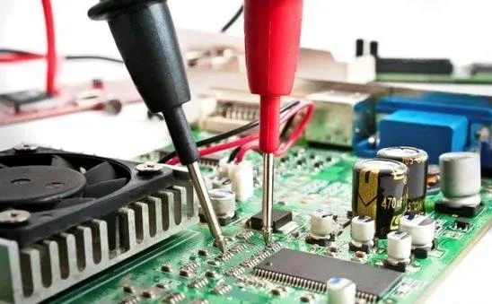 Image showing measurement probes testing electronic components on a circuit board to illustrate zero-ohm resistor application.