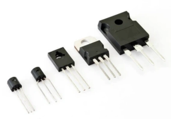 Five through-hole transistors of increasing size arranged diagonally, showcasing different electronic component packages from small-signal to power transistor on white background.