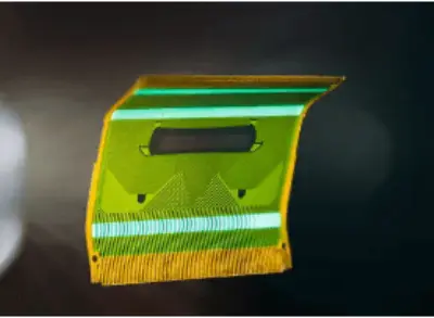 A curved flexible PCB being molded, highlighting its ability to fit into complex, non-planar designs in advanced electronic devices.