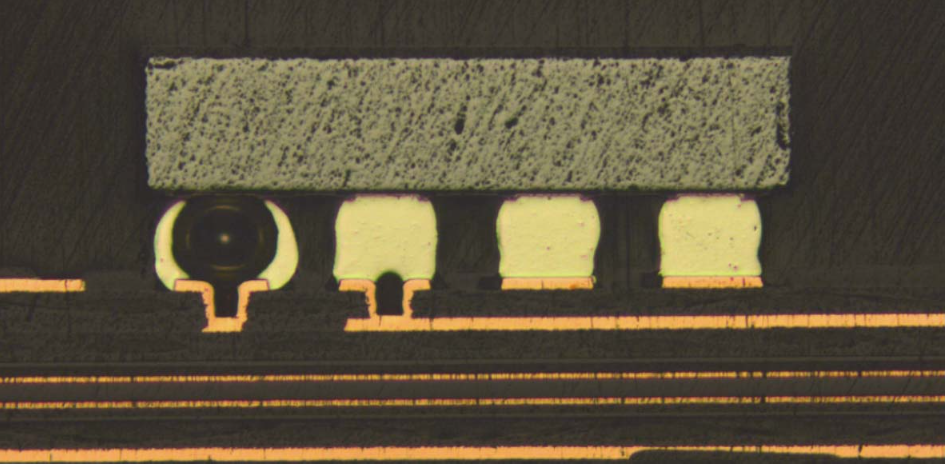 Cross-section micrograph showing solder joint voids caused by improper HDI laser microvia filling, illustrating the risk of air entrapment in Via-in-Pad designs.