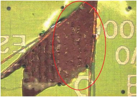 Photo of a contaminated browning surface, circled area showing contamination